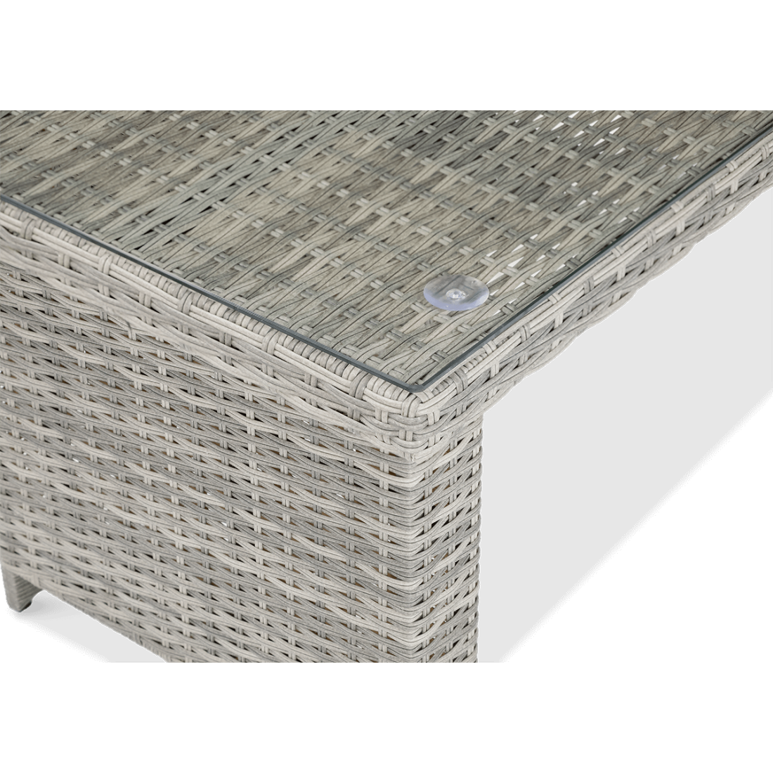 Zbliżenie na stół przykryty hartowanym szkłem zestawu technorattanowego MONIZ DINING PLUS Stone Grey