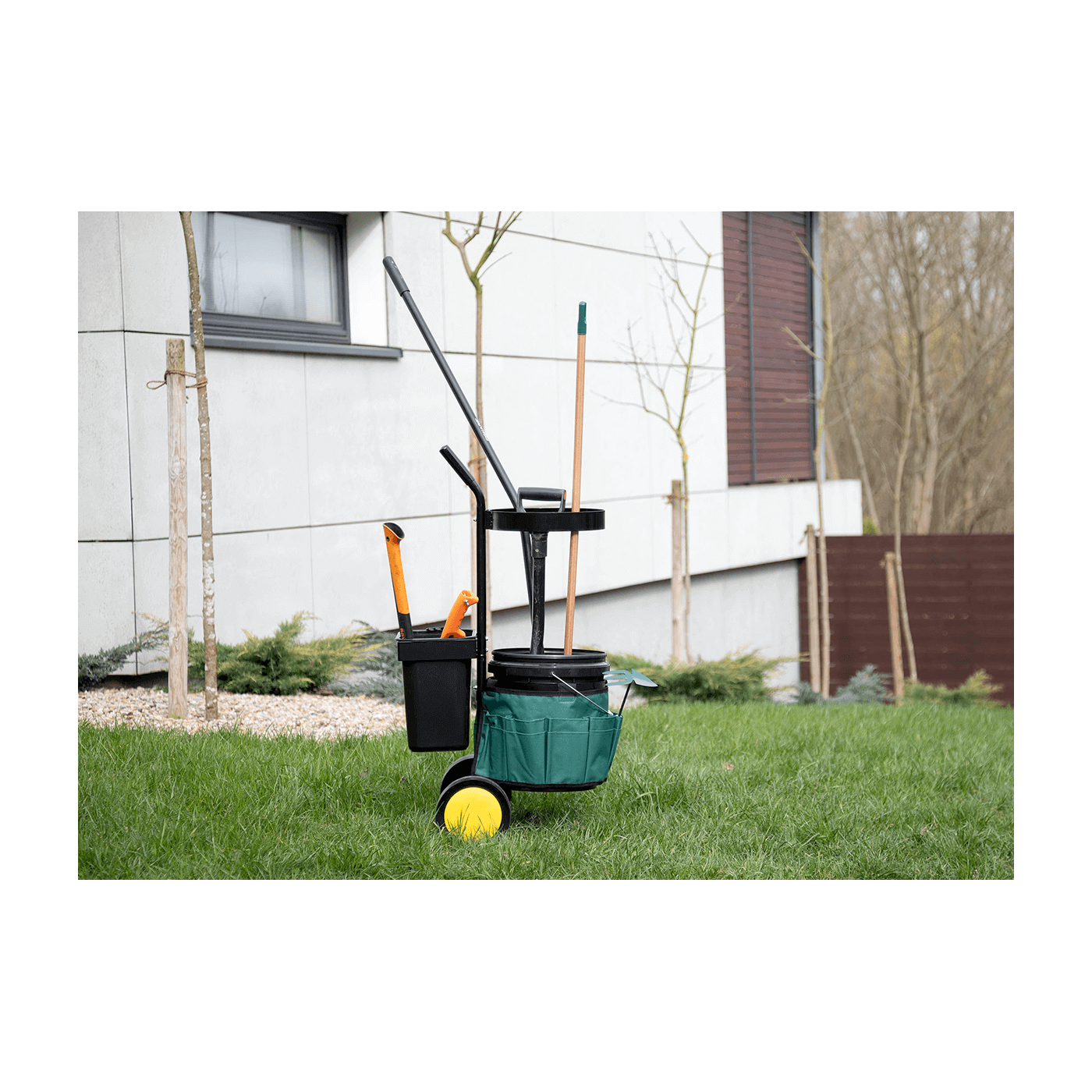 Widok na wózek ogrodowy z narzędziami na zielonej trawie